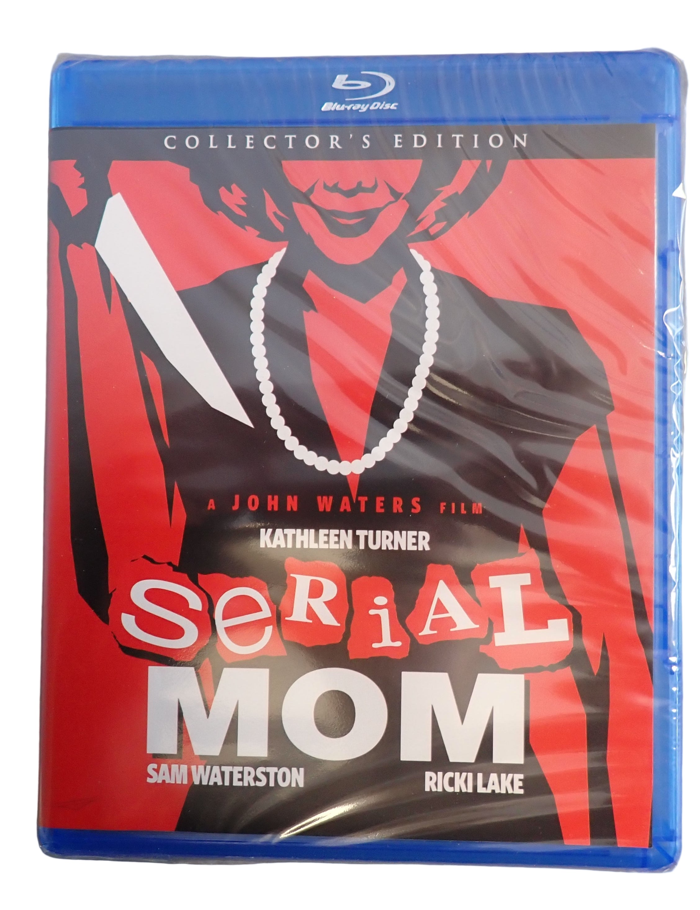Blu-ray cover of 'Serial Mom' with a stylized image of a woman on a red background.