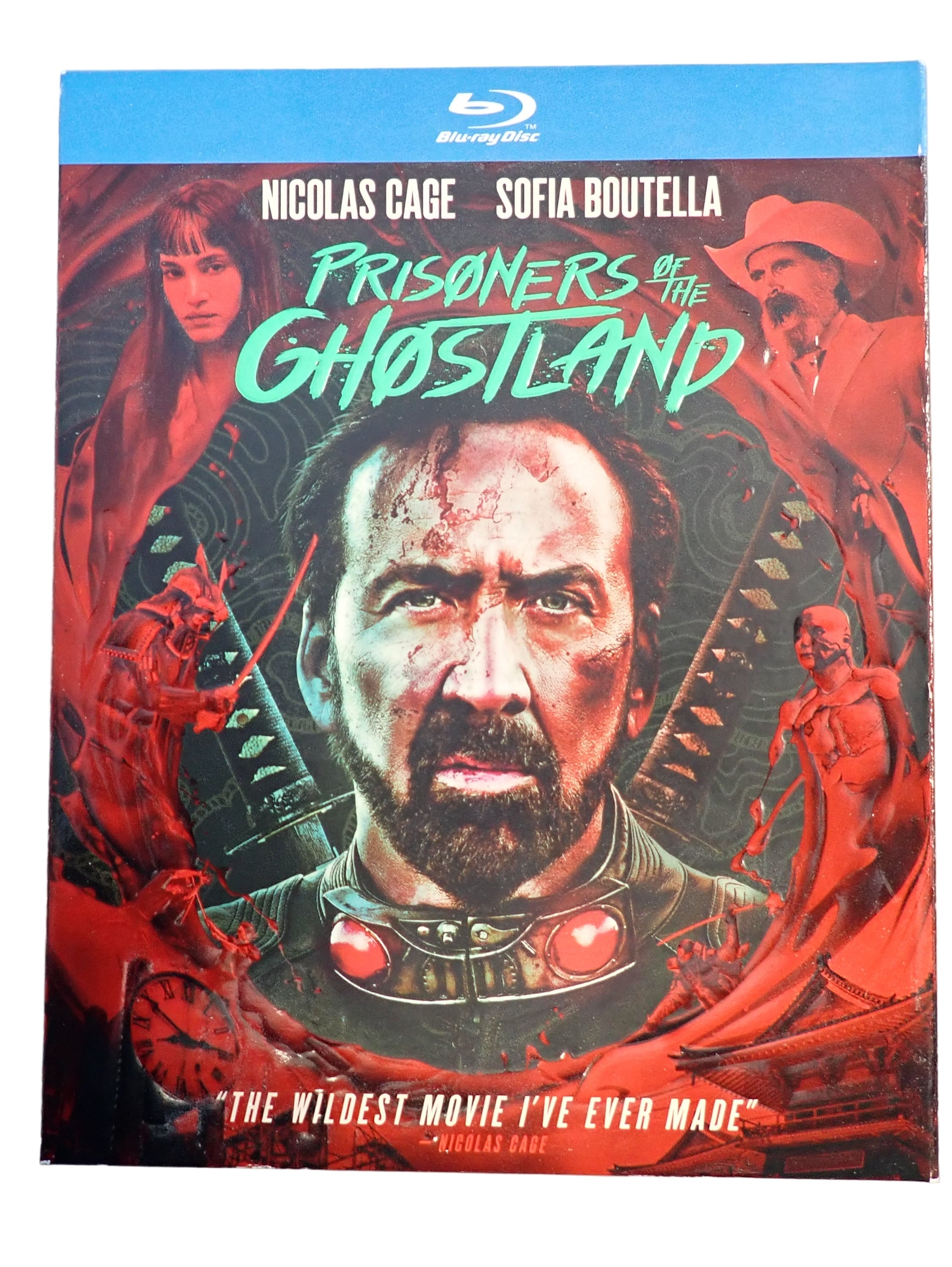 Blu-ray cover of 'Prisoners of the Ghostland' with Nicolas Cage and Sofia Boutella on a gray background